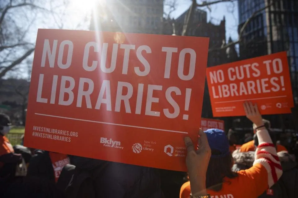 The bottom shows Geordi approving with a text “ending the cycle of instability and ensuring library funding” The bottom image captures a protest or advocacy event in support of library funding. People in the crowd are holding up bright orange signs that read: "NO CUTS TO LIBRARIES!”